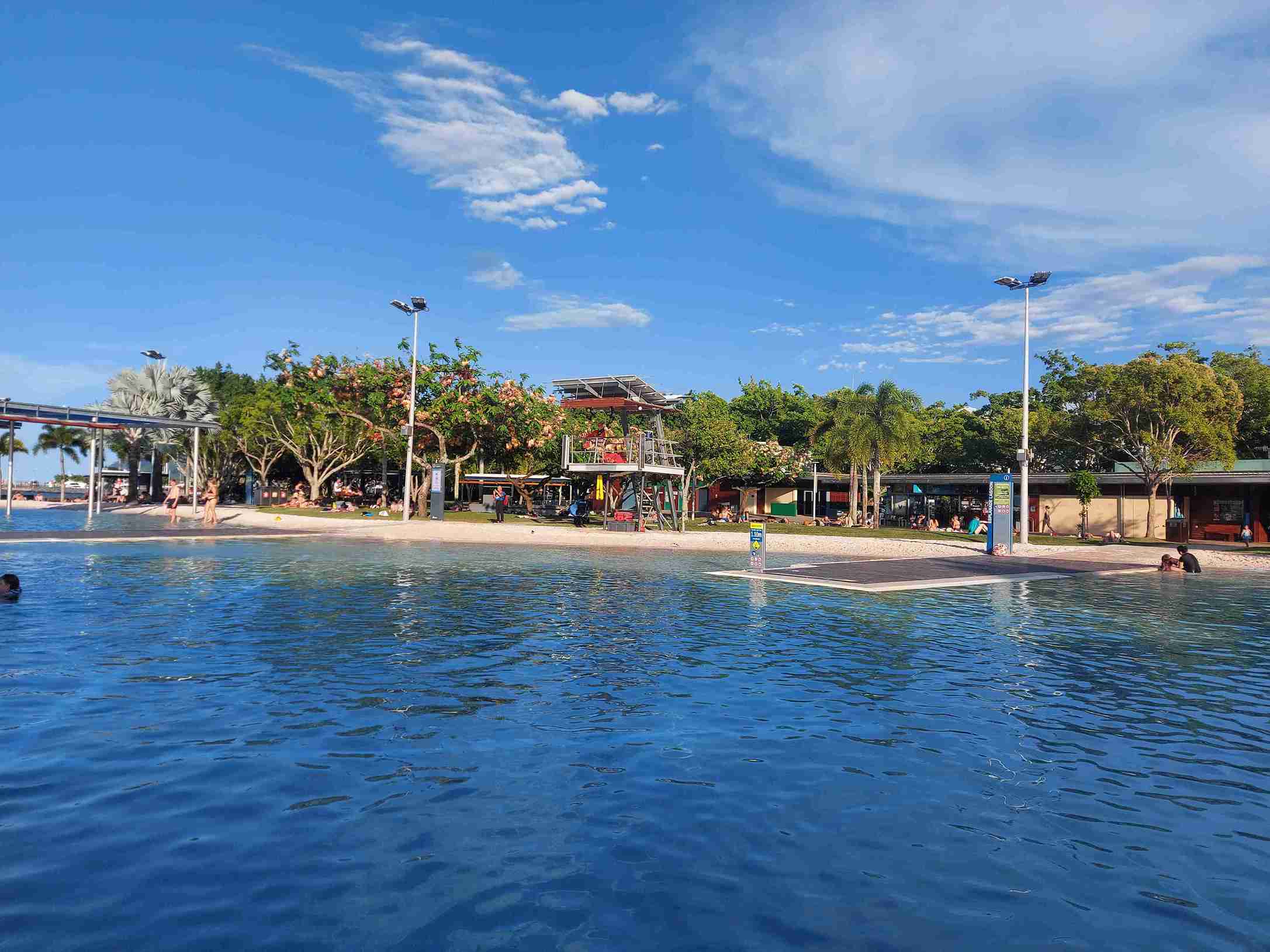 Body of water surrounded by trees and a lifeguard tower